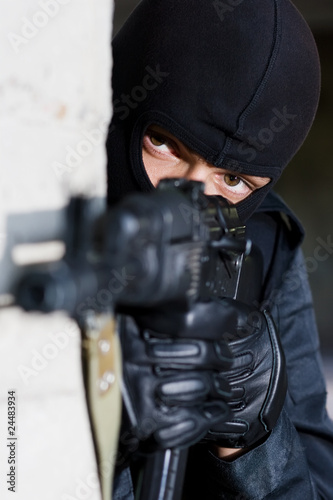 Soldier in black uniform with rifle photo