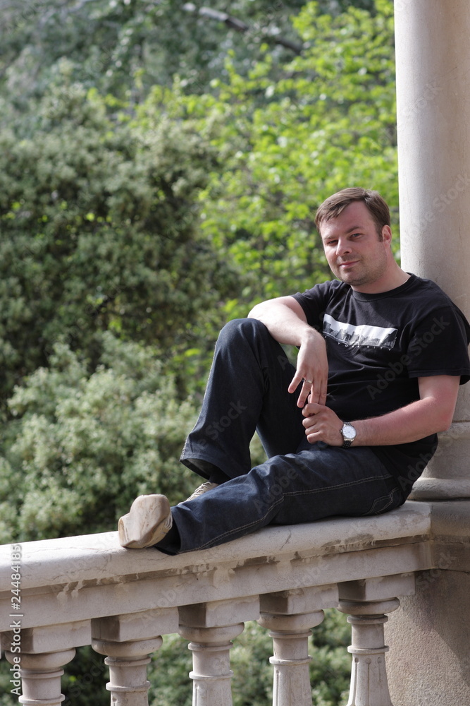Man leans against column Man leans against column