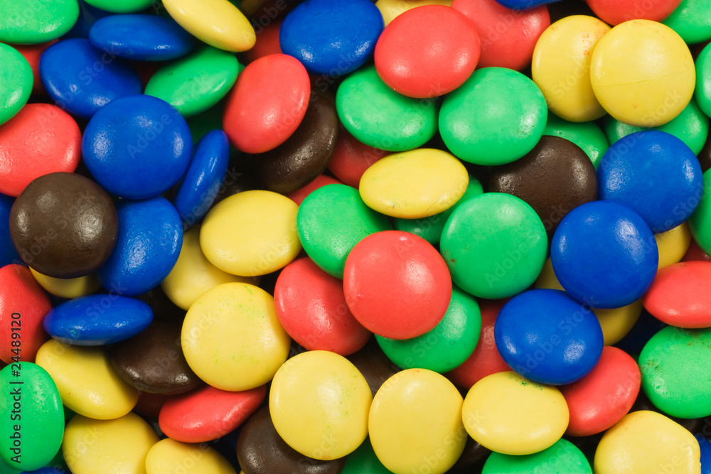 background of multicolored candy coated chocolate sweets background of multicolored candy coated chocolate sweets