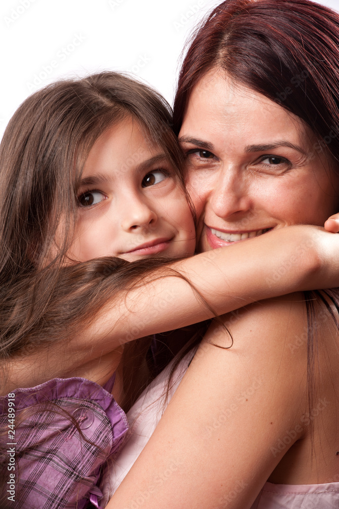 Studio portrait of a cute little girl hugging her mother Studio portrait of a cute little girl hugging her mother