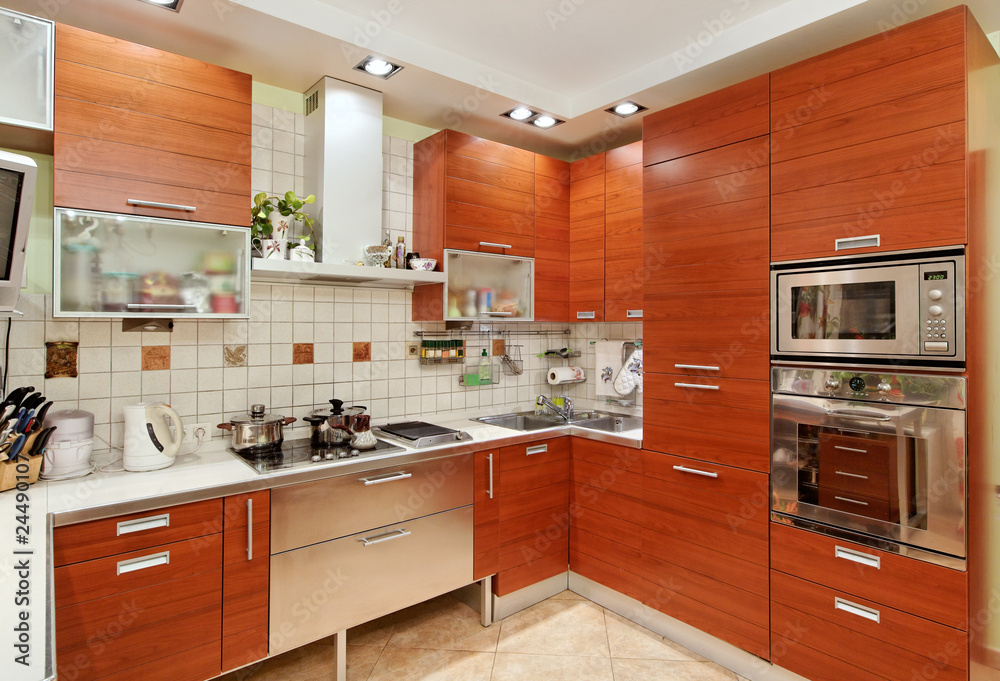 Kitchen interior with wooden furniture and build in utensils Kitchen interior with wooden furniture and build in utensils