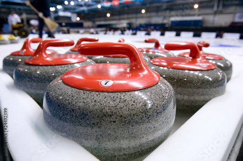 Fotografie Group of curling rocks on ice