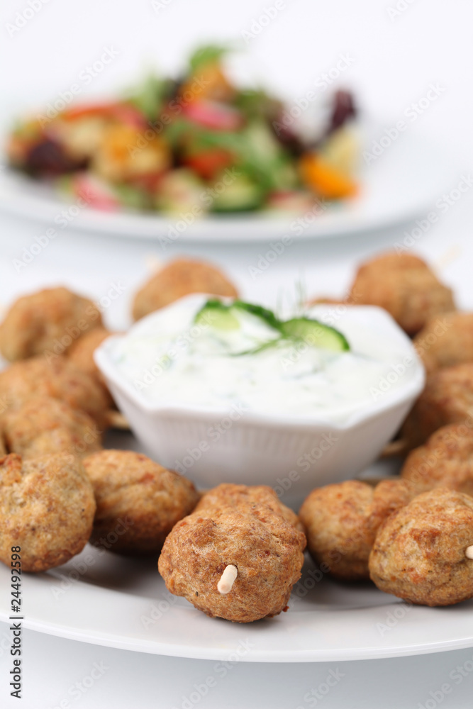 Roast meatballs on skewers and tzatziki dip. Shallow DOF Roast meatballs on skewers and tzatziki dip. Shallow DOF