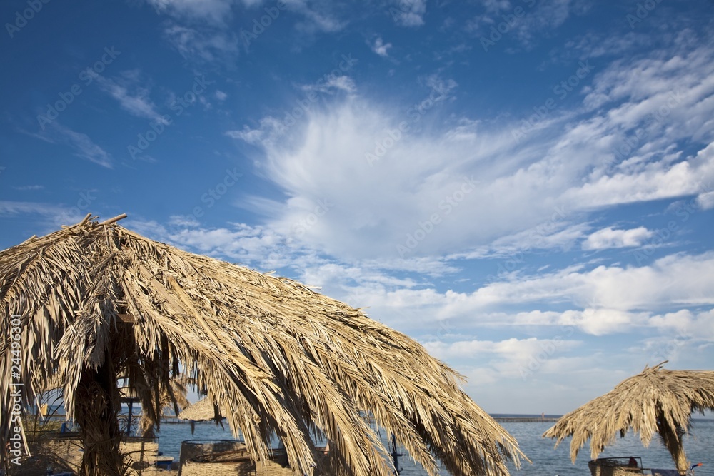 Palm leaves umbrella on an exotic beach in Egypt Palm leaves umbrella on an exotic beach in Egypt