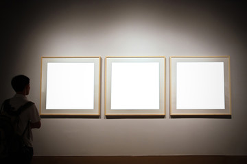 empty exhibition frames and person looking