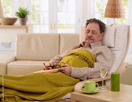 Billede på lærred Senior man napping in armchair
