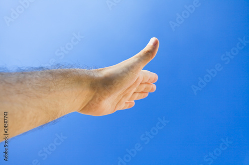 Hand against the blue sky