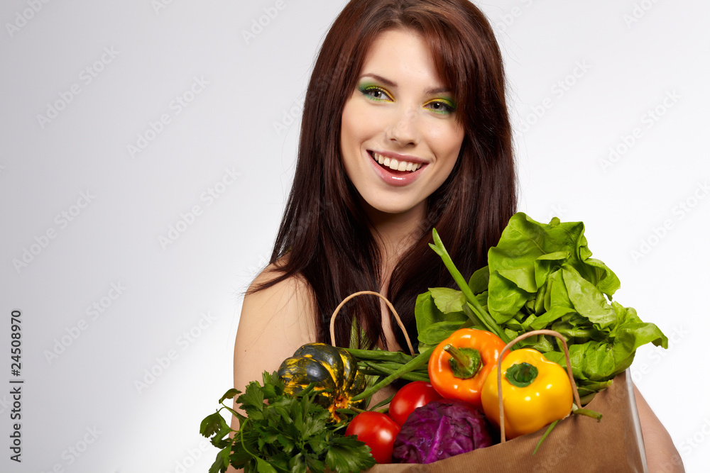 woman holding a grocery bag full of fresh and healthy food isola woman holding a grocery bag full of fresh and healthy food isola