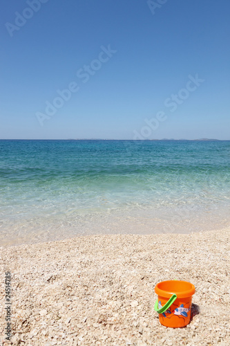 beautiful beach with child s bucket