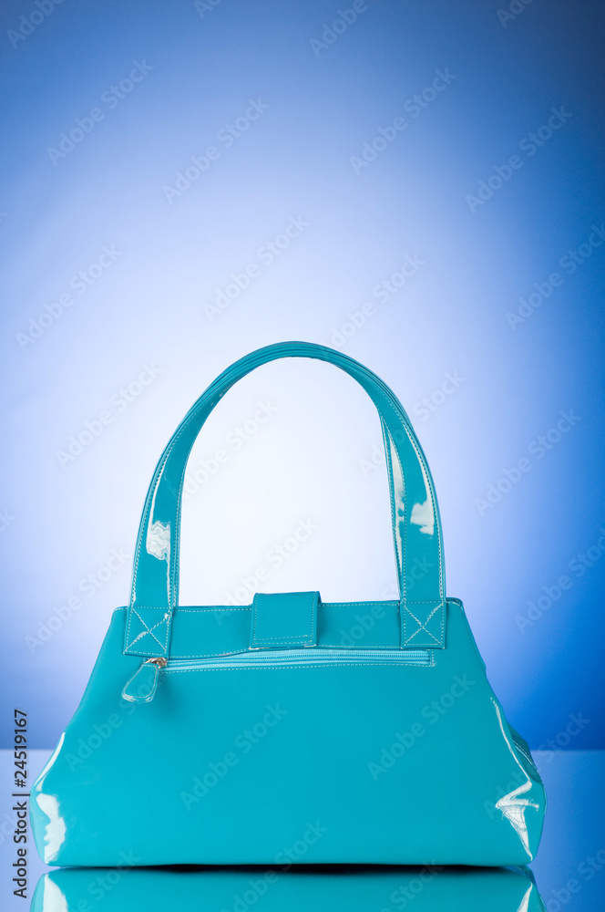 Blue bag against the colorful gradient background Blue bag against the colorful gradient background