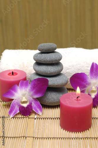 Spa with white candles on a brown backdrop