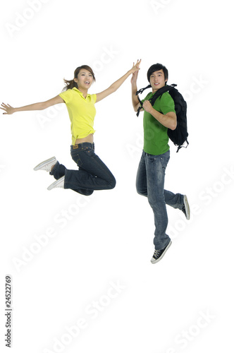 couple jumping - over a white background
