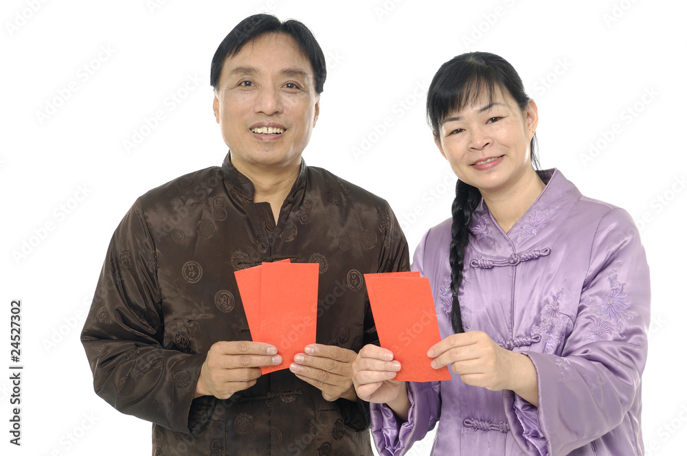 Couple wearing traditional dress holding a red packet Couple wearing traditional dress holding a red packet