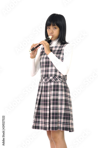 young girl is playing on a flute