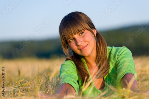 Portrait of happy woman in sunset corn field