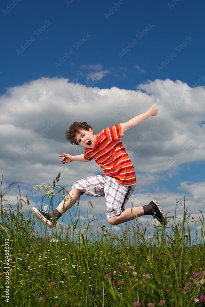 Boy jumping, running against blue sky Boy jumping, running against blue sky