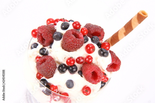 Whipped cream with raspberries, red currants and blue berries