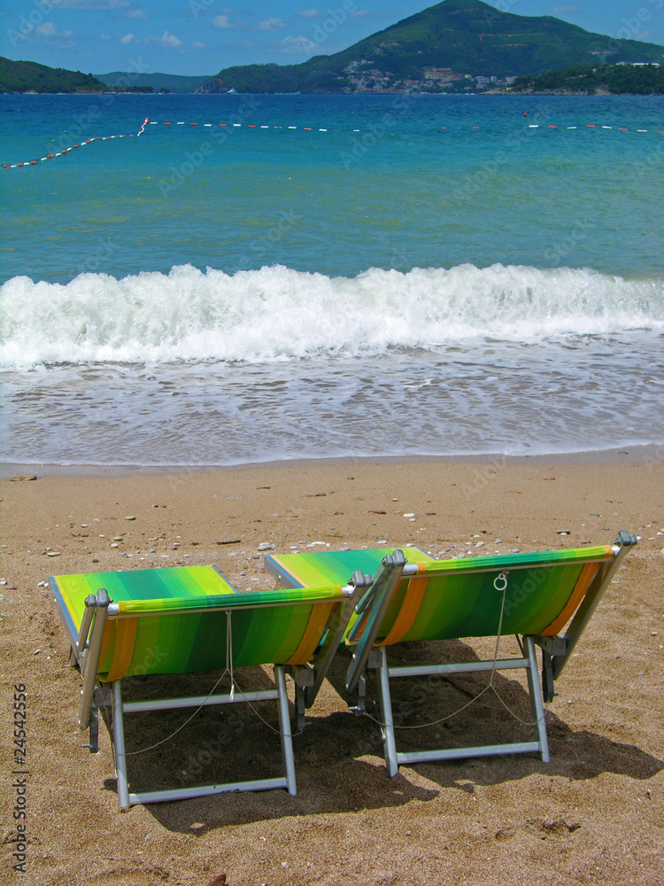 Two sunbeds at the beach Two sunbeds at the beach