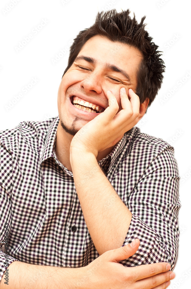 young man laughing with his eyes closed isolated on white young man laughing with his eyes closed isolated on white