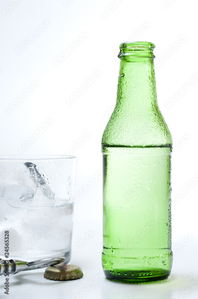 Bottle and glass of mineral water on white background Bottle and glass of mineral water on white background