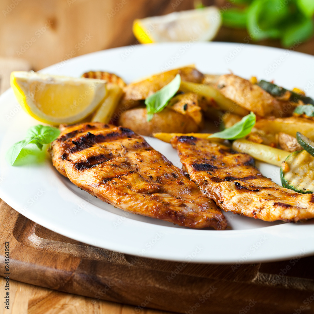 Grilled chicken breast with vegetables and lemon