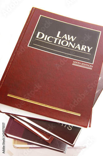 law dictionary books stacked, on white