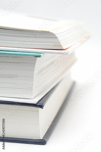 Stack of three books, upper is opened