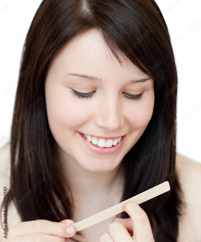 Portrait of a beautiful woman filing her nails Portrait of a beautiful woman filing her nails