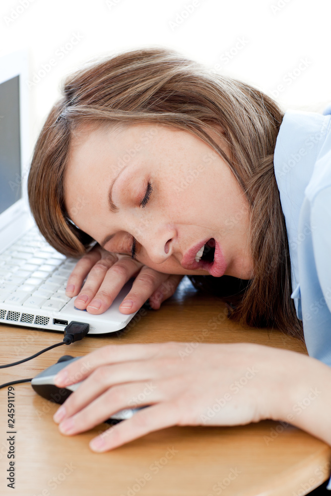 Naklejka premium Tired young woman sleeping in her office