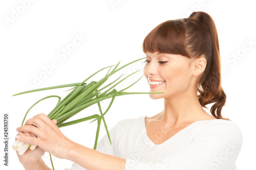 beautiful housewife with spring onions over white