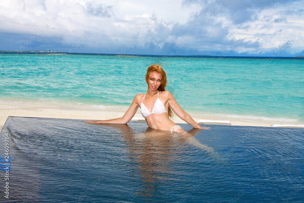 Young pretty woman in the pool and ocean . Maldives Young pretty woman in the pool and ocean . Maldives