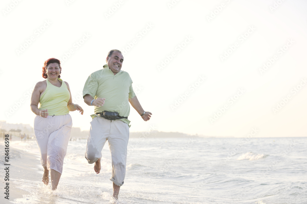 happy seniors couple  on beach