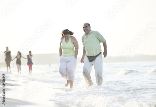 happy seniors couple on beach