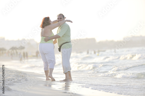happy seniors couple on beach