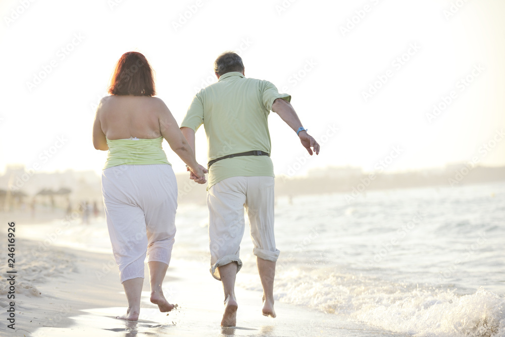 happy seniors couple  on beach