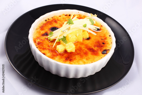 Delicious french dessert creme brulee in porcelain bowl