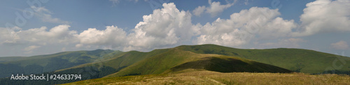 White summer clouds above Carpathian mountain meadows panorama