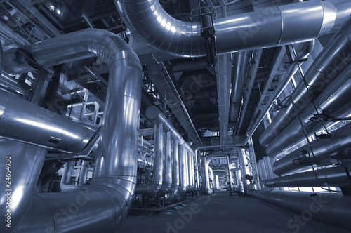 Equipment, cables and piping as found inside of a modern industr