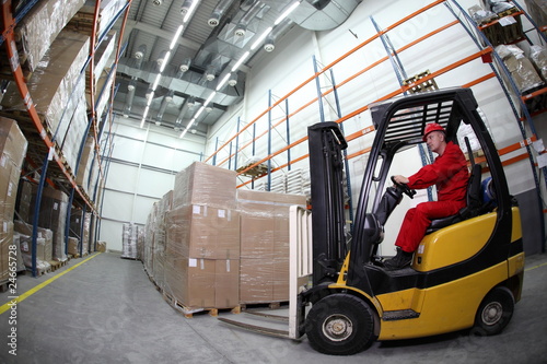 forklift operator at work in warehouse photo