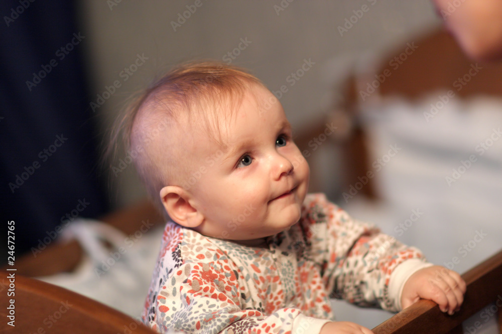 Funny baby stands on his bed