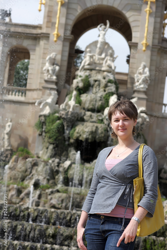 Tourist poses on fountain background