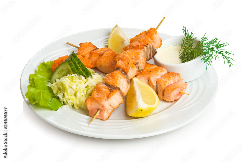 Salmon kebab with sauce and vegetable side dish Salmon kebab with sauce and vegetable side dish