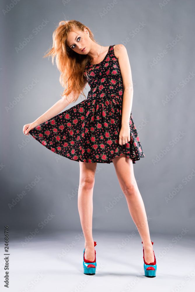 Beautiful red-haired girl on grey background Beautiful red-haired girl on grey background