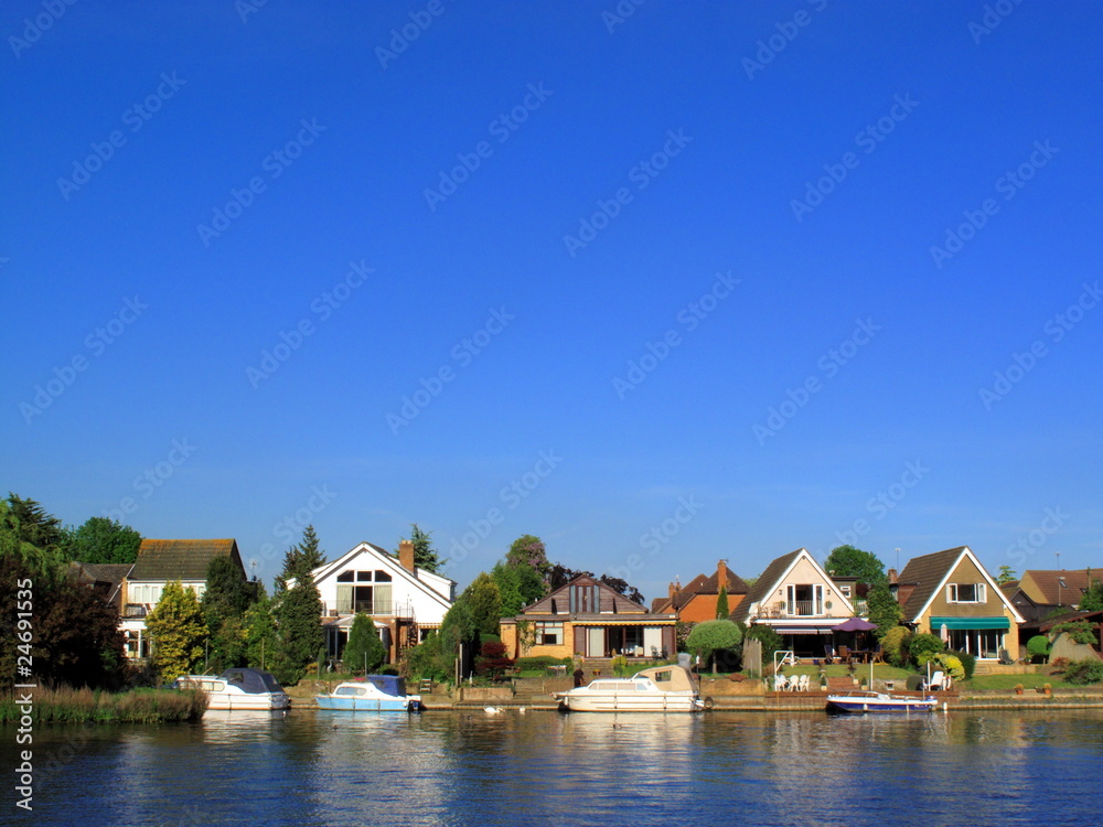 Homes and moored boats on the River Thames at Windsor