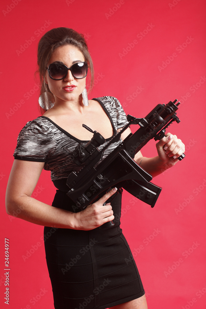 Young and sexy woman with an assault gun. Young and sexy woman with an assault gun.
