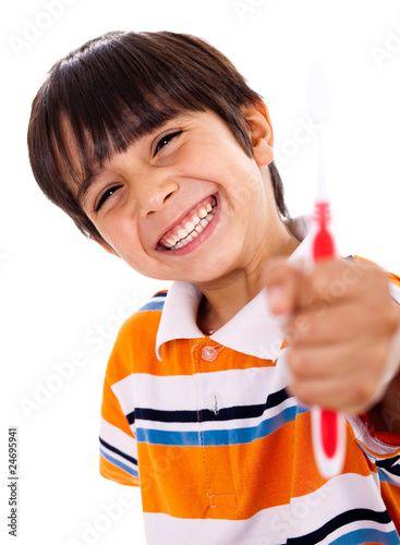 Happy young boy showing the toothbrush photo