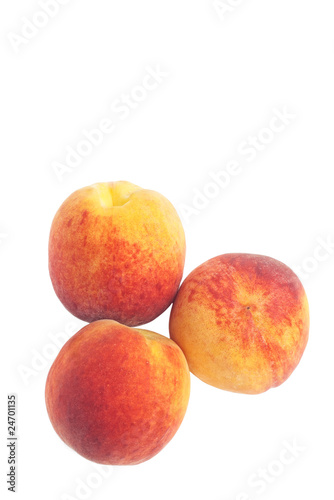 Closeup of three peaches isolated on white with copy space
