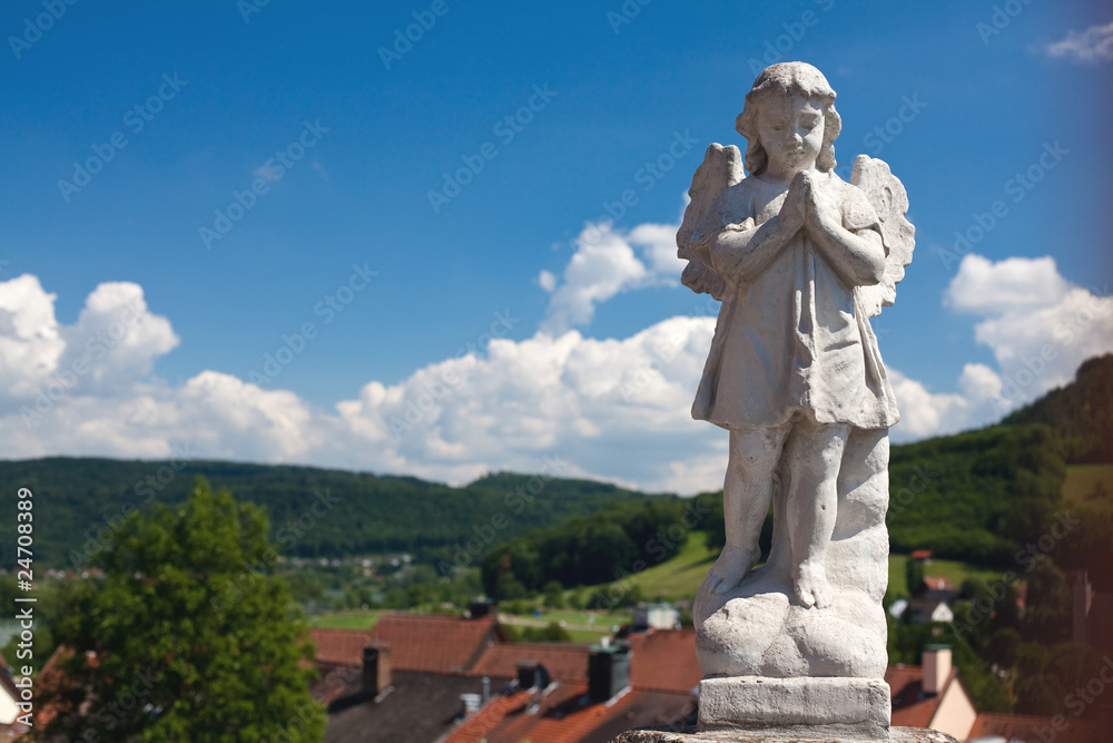 statue of angel abow the town and sky