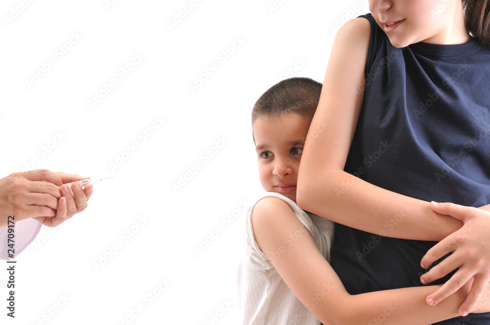 Little boy scared of injection hugging his sister. Stock Photo | Adobe ...