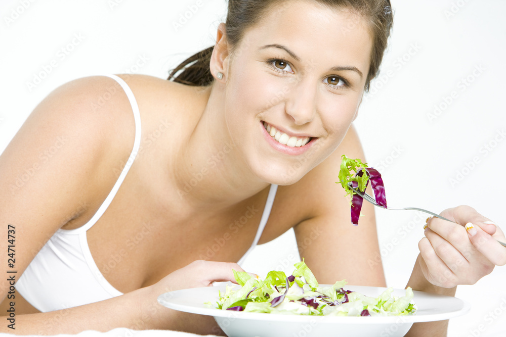 portrait of lying down woman eating salad portrait of lying down woman eating salad
